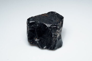 Natural black obsidian stone on white background