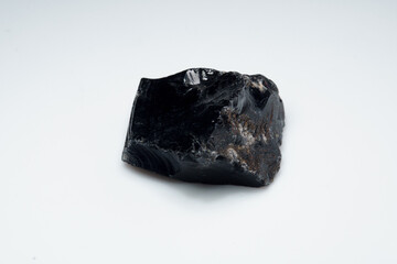 Natural black obsidian stone on white background