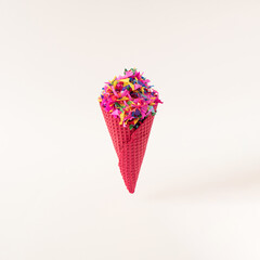 Red ice cream cone with colorful confetti. Minimalistic summer party composition. Copy space.