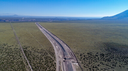 Aerial view of road under construction in the field.