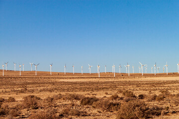 Electric wind turbines in the rocky desert