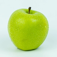 Perfect fresh green apple with water drops isolated on white background.