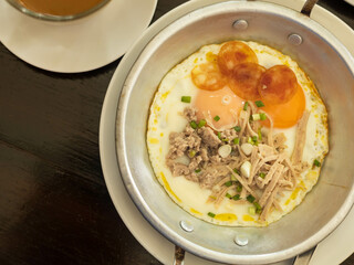 panned egg food with sausage and pork chops in a metal dish,  delicious breakfast in the morning
