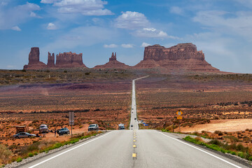 Monument Valley taken on Forrest Gump hills with a straight road to the Monument Valley
