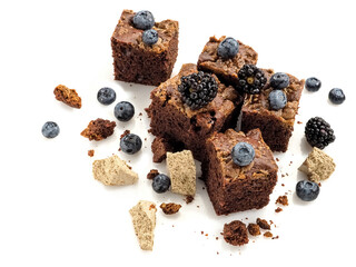 Brownie pieces with halva, blackberries and blueberries, close up