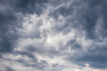 Fototapeta premium Dark stormy sky with bizarre torn clouds before the rain