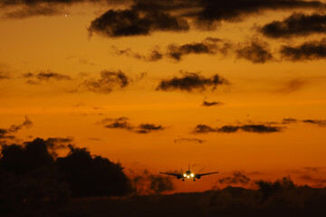 sunset in the airport with a plane landing