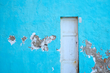 White door in blue wall, typical Mediterranean house detail.