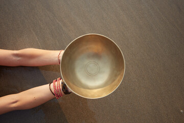 hand holding tibetian bowl