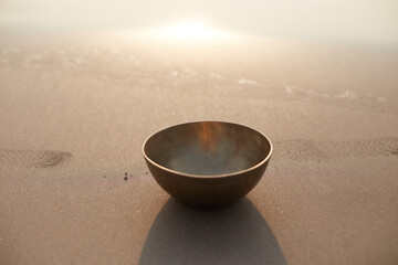 Singing tibetian bowl sea background