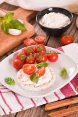 Rice cakes with milk flakes and tomato.