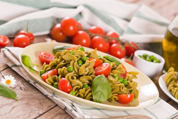 Fusilli pasta with cherry tomatoes and peas.