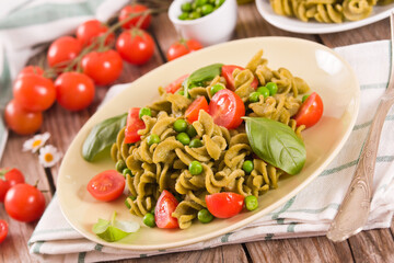 Fusilli pasta with cherry tomatoes and peas.