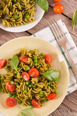 Fusilli pasta with cherry tomatoes and peas.