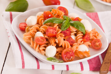 Fusilli pasta with cherry tomatoes and mozzarella cheese.