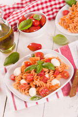 Fusilli pasta with cherry tomatoes and mozzarella cheese.