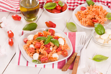 Fusilli pasta with cherry tomatoes and mozzarella cheese.