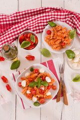 Fusilli pasta with cherry tomatoes and mozzarella cheese.