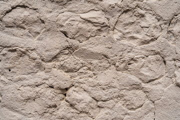 Close up of an old stone wall in Honfleur, France, for an abstract background texture.