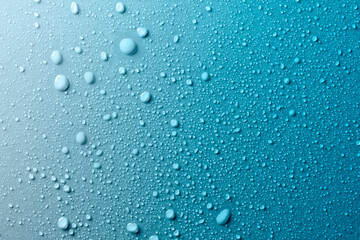 Water drops on smooth surface, blue background - obrazy, fototapety, plakaty