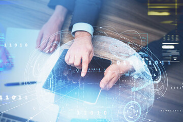 Businessman in formal suit is touching tablet with his finger