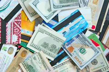 Hundred dollar notes and credit cards. Pile of credit cards in dollars