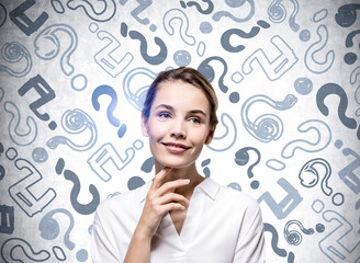Thoughtful smiling businesswoman wearing shirt is touching chin
