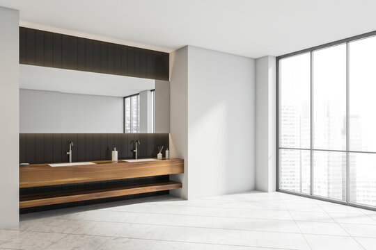 Corner of white bathroom with wood alike vanity