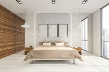 Three posters on grey wall of modern white wood bedroom