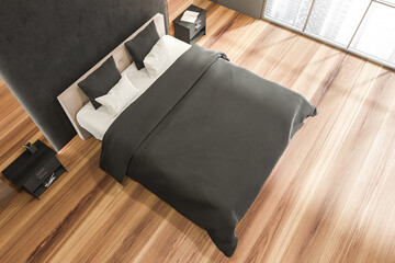 Bedroom with wooden floor and dark stone wall detail. Top view.