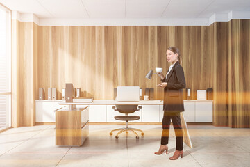 Businesswoman wearing formal suit is standing and drinking coffe