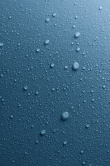 Water drops on smooth surface, blue background