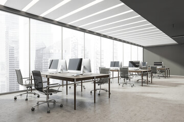 Open space office interior with panoramic view and grey concrete floor