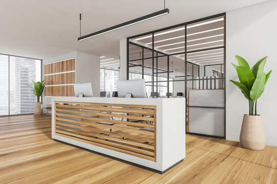 Corner of white office reception with wood panels and open space