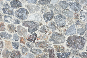 Blurred stone wall with snowflakes as background