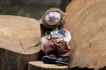 plush toy witch on wooden background