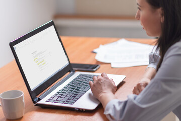 Woman working at home office hand on keyboard close up