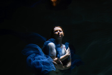 Beautiful girl underwater in the pool. Black and white photography, creative and mystical