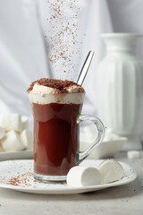 Hot chocolate with marshmallows sprinkled with chocolate crumbs.