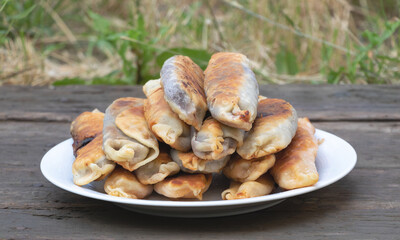 Close up shot of fresh and delicious pies with cherries. On wooden Background