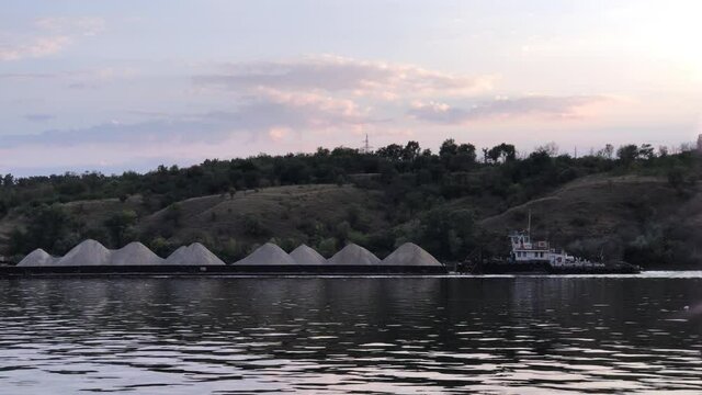 loaded barge on the river evening water cloud