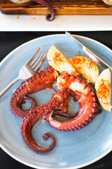 Pulpo Gallego -  whole galician octopus. Cooked octopus served with potatoes and paprika