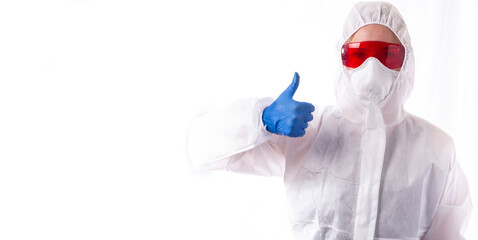 A woman in a white chemical protection suit shows a thumb on a white background, disinfection, pest...