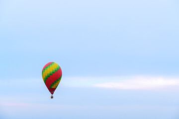 Fototapeta na wymiar Hot air balloon with light blue evening sky