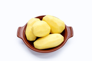 Peeled potatoes in bowl on white background