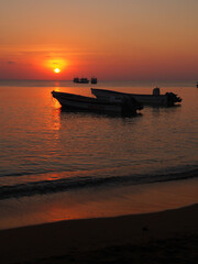 Sunset with two boats in the foreground