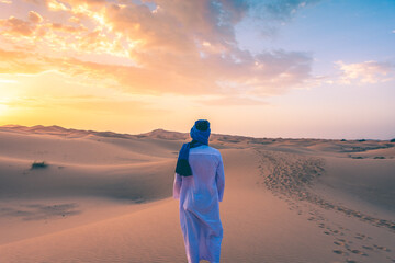 Berber man wearing traditional tuareg clothes in the Sahara Desert at dawn, Merzouga, Morocco