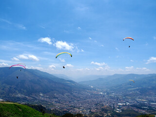 Medellin, Colombia - 20.05.2015: Paragliders flying above Medellin