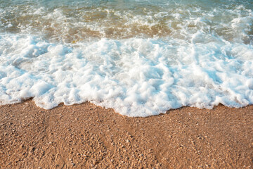 Fototapeta na wymiar Sea foam on the beach, top view