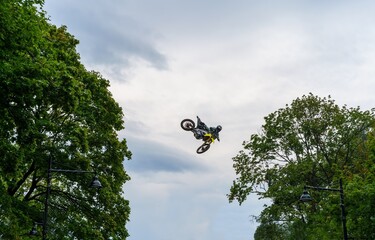 Motocross rider jumps high into the air